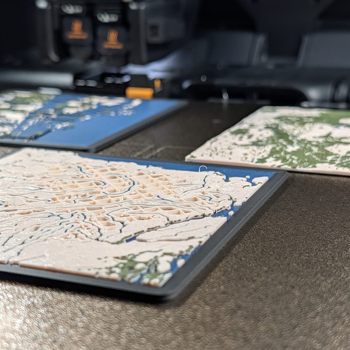 A spread of custom 3D topographic map prints