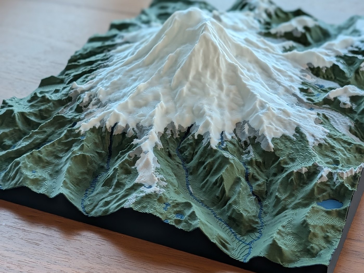 A finished 3D-printed topographic relief map on a table